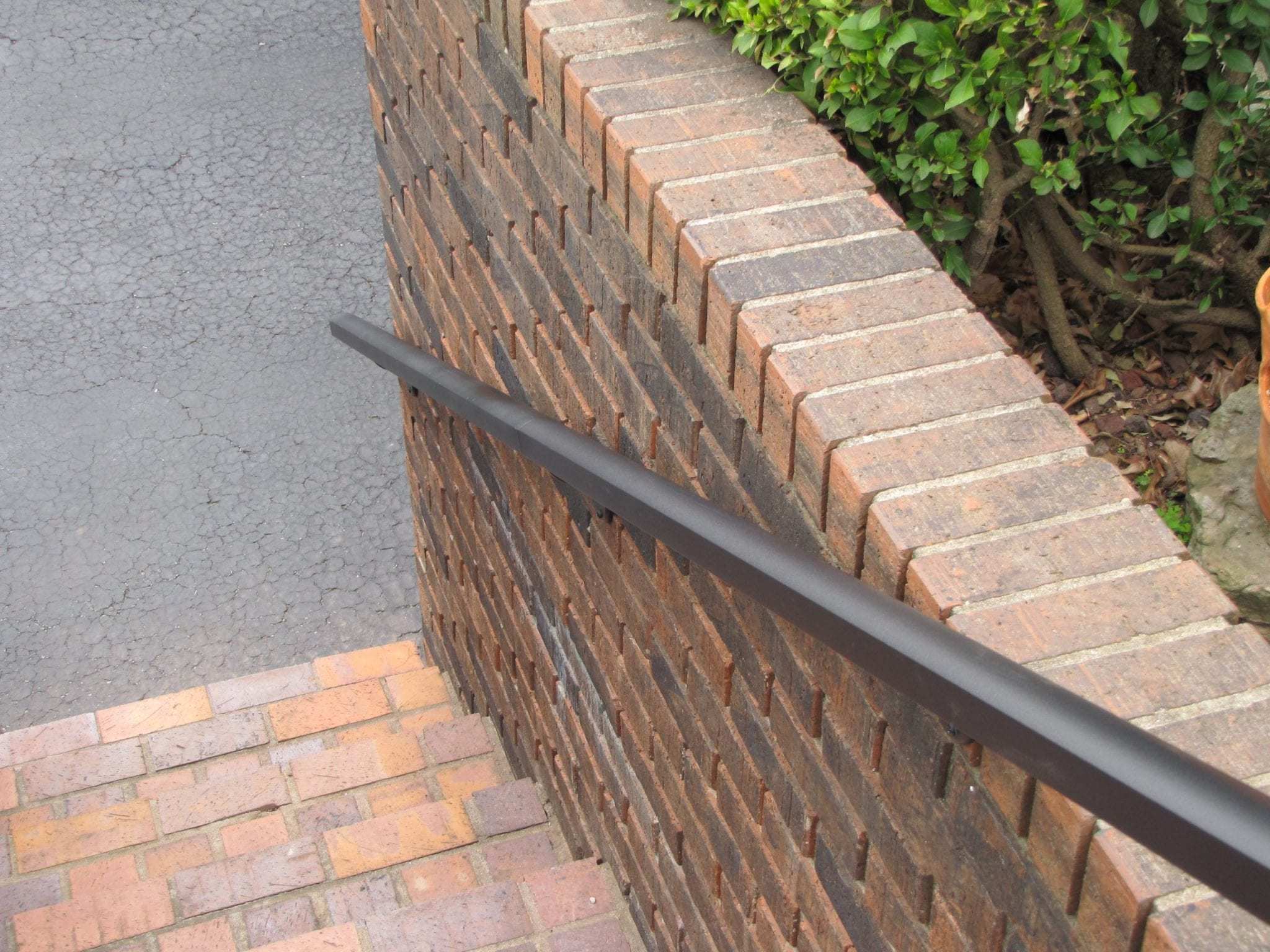 Aluminum Handrail Direct, overhead shot of aluminum handrail on brick wall