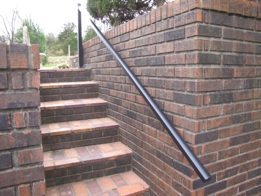 Aluminum Handrail Direct handrail on brick wall beside stairs