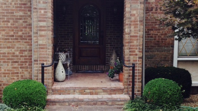 Aluminum handrails on either side of entryway to home