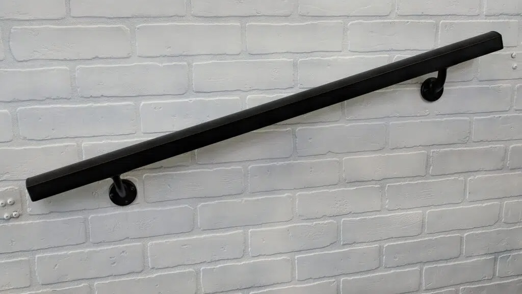 AHD aluminum black handrail on white brick wall
