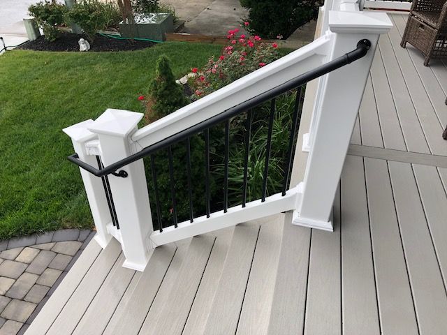 AHD black handrail attached to white railing